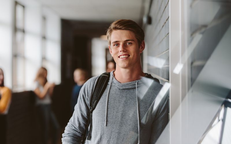 boy with backpack in hallway