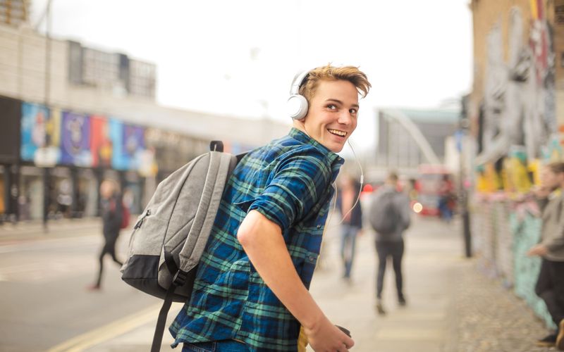 boy with backpack on street