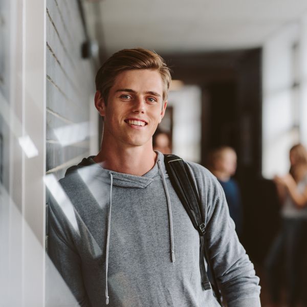 boy with backpack in hallway flipped