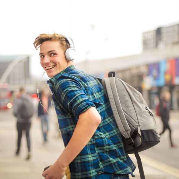 boy with backpack and headphones